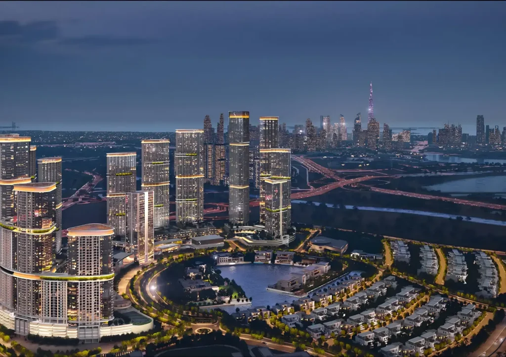 i mixed-use masterplan at night with illuminated towers and Burj Khalifa skyline — buying property in Dubai